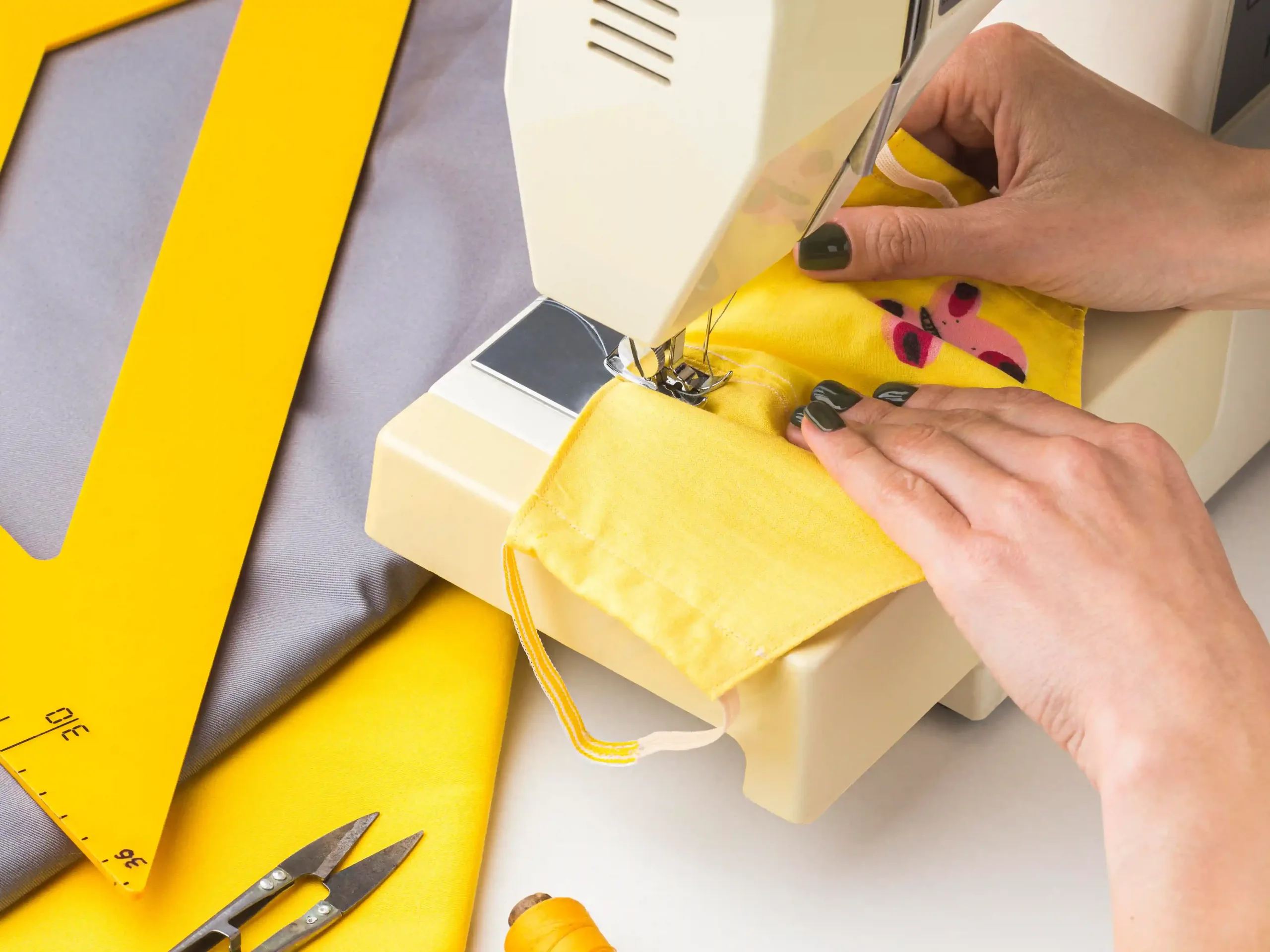 Tailor working with yellow fabric