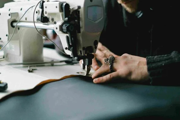 Close up of hands using a sewing machine