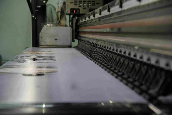 Close up of hands using a sewing machine