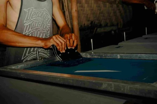 Tailor working with denim fabric at a workbench